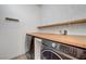 Laundry room features wood counters and sleek, modern washer and dryer units at 1069 Aspen Cliff Dr, Henderson, NV 89011