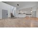 Bright open-concept floor plan featuring hardwood floors and access to the staircase and a modern kitchen at 1069 Aspen Cliff Dr, Henderson, NV 89011