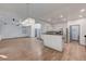 Open-concept living space features wood-look flooring and a kitchen with stainless steel appliances at 1069 Aspen Cliff Dr, Henderson, NV 89011
