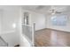 Bright, open living space with wood-look floors and ceiling fan, adjacent to staircase at 1069 Aspen Cliff Dr, Henderson, NV 89011