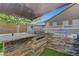The outdoor kitchen includes stone accents and dual built-in stainless steel barbecue grills at 1069 Aspen Cliff Dr, Henderson, NV 89011