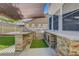Elegant outdoor kitchen has granite countertops and a built-in grill perfect for entertaining at 1069 Aspen Cliff Dr, Henderson, NV 89011