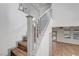 Bright two story foyer with wood staircase and railing leading to the second floor at 1069 Aspen Cliff Dr, Henderson, NV 89011