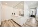 Modern bathroom featuring double sinks, a large mirror, and sleek, minimalist design elements at 12093 Glentana View St, Las Vegas, NV 89138