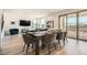 Open concept dining area with wood floors and a large table set for dinner at 12093 Glentana View St, Las Vegas, NV 89138
