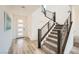Bright entryway with modern staircase, wood-look floors, and contemporary front door at 12093 Glentana View St, Las Vegas, NV 89138