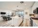 Open concept kitchen and dining area with island seating and stainless steel appliances at 12093 Glentana View St, Las Vegas, NV 89138