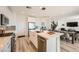 Modern kitchen with white cabinets, stainless appliances, and an island with seating at 12093 Glentana View St, Las Vegas, NV 89138