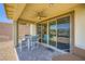 Cozy covered patio with an outdoor dining set and sliding glass doors for seamless indoor/outdoor living at 12093 Glentana View St, Las Vegas, NV 89138