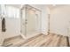 Contemporary shower with glass enclosure, rainfall showerhead and stone tile accents at 12093 Glentana View St, Las Vegas, NV 89138