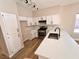 Bright kitchen featuring white cabinets, stainless steel appliances, and a large island at 1333 Pacific Terrace Dr, Las Vegas, NV 89128