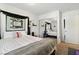 Light bedroom featuring carpet floors, comfortable bed, and mirrored closet doors at 135 Cadrow Castle Ct, Las Vegas, NV 89148
