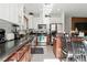 Modern kitchen featuring stainless steel appliances, granite countertops, and dark wood cabinets at 135 Cadrow Castle Ct, Las Vegas, NV 89148