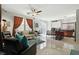 Open-concept living room connected to kitchen with tile floors and plenty of natural light at 135 Cadrow Castle Ct, Las Vegas, NV 89148