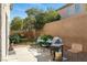 Cozy backyard patio with a grill, seating, and lush landscaping for outdoor enjoyment at 135 Cadrow Castle Ct, Las Vegas, NV 89148