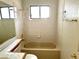 This bathroom features a tiled shower-tub combination, a window for light, and neutral colors at 1409 Santa Margarita St # B, Las Vegas, NV 89146