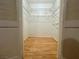 Open walk-in closet with metal racks and wood flooring at 1409 Santa Margarita St # B, Las Vegas, NV 89146