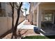 Backyard showcasing low maintenance landscaping and a covered patio area at 1700 Double Arrow Pl, Las Vegas, NV 89128