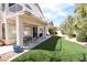 Backyard featuring artificial turf, a patio, and lush landscaping at 1700 Double Arrow Pl, Las Vegas, NV 89128