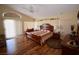 Spacious bedroom with a ceiling fan, wood floors, and a king-sized bed at 1700 Double Arrow Pl, Las Vegas, NV 89128