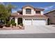 Charming two-story home with a spacious three-car garage and manicured landscaping at 1700 Double Arrow Pl, Las Vegas, NV 89128