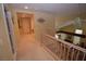 Hallway view of stairway featuring a modern chandelier and neutral-toned decor at 1700 Double Arrow Pl, Las Vegas, NV 89128