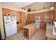 A well-lit kitchen with a central island with wine storage and ample cabinet space at 1700 Double Arrow Pl, Las Vegas, NV 89128