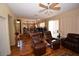 Sun-lit living room with a ceiling fan, hardwood floors, and comfortable seating at 1700 Double Arrow Pl, Las Vegas, NV 89128