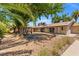 Expansive backyard with shaded trees, lounge seating and a spacious patio at 1911 Valley Dr, Las Vegas, NV 89108