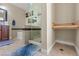 Bathroom with a glass-enclosed shower, a built-in bench, and a tiled accent border at 1911 Valley Dr, Las Vegas, NV 89108