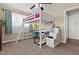 Bedroom with a lofted twin bed over a desk space and carpeted floors at 1911 Valley Dr, Las Vegas, NV 89108