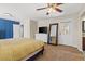Primary bedroom featuring a ceiling fan, plush carpet, blue accents, and a white door to the outside at 1911 Valley Dr, Las Vegas, NV 89108