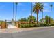 Ranch style house with palm trees and a secure wood gate entrance, framed by desert landscaping at 1911 Valley Dr, Las Vegas, NV 89108