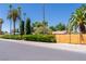 View of residential property showcasing mature landscaping, a wooden fence, and curb appeal at 1911 Valley Dr, Las Vegas, NV 89108