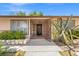 Inviting front entrance with unique decorative ironwork, mature landscaping, and a secure gated entry at 1911 Valley Dr, Las Vegas, NV 89108