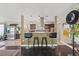 Open kitchen area featuring dark wood floors, breakfast bar with seating, and stainless steel appliances at 1911 Valley Dr, Las Vegas, NV 89108