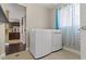 Bright laundry room featuring a modern washer and dryer set with tile flooring at 1911 Valley Dr, Las Vegas, NV 89108