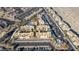 Aerial view of an apartment complex with palm trees around a pool and lots of covered parking spaces at 2016 Mesquite Ln # 104, Laughlin, NV 89029