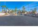 Community entrance to Portofino Condominiums with lush landscaping and palm trees at 2016 Mesquite Ln # 104, Laughlin, NV 89029