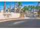 Community entrance sign featuring palm trees and desert landscaping at 2016 Mesquite Ln # 104, Laughlin, NV 89029