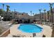 Resort-style community pool with ample seating and palm tree landscaping at 2016 Mesquite Ln # 104, Laughlin, NV 89029