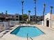 Inviting community pool with lounge chairs, spa, and beautiful palm trees at 2016 Mesquite Ln # 104, Laughlin, NV 89029