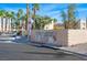 Portofino Condominiums brick sign with mature landscaping and palm trees at 2016 Mesquite Ln # 104, Laughlin, NV 89029