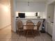 Bright dining area with wooden table and view into the kitchen at 2016 Mesquite Ln # 104, Laughlin, NV 89029