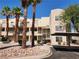 Multi-level condo building boasting palm trees and convenient covered parking at 2016 Mesquite Ln # 104, Laughlin, NV 89029