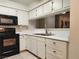 Clean kitchen features white cabinets and black appliances for contrast at 2016 Mesquite Ln # 104, Laughlin, NV 89029