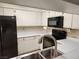 Spacious kitchen featuring stainless steel sink and black appliances at 2016 Mesquite Ln # 104, Laughlin, NV 89029