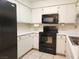 Well-lit kitchen with black appliances and abundant counter space at 2016 Mesquite Ln # 104, Laughlin, NV 89029