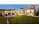 Expansive backyard with pool, grass, covered patio, and mature trees, ideal for outdoor activities at 2172 De Rouge Ave, Henderson, NV 89044
