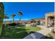 Spacious backyard with manicured lawn, mature trees, and a resort-style pool at 2172 De Rouge Ave, Henderson, NV 89044